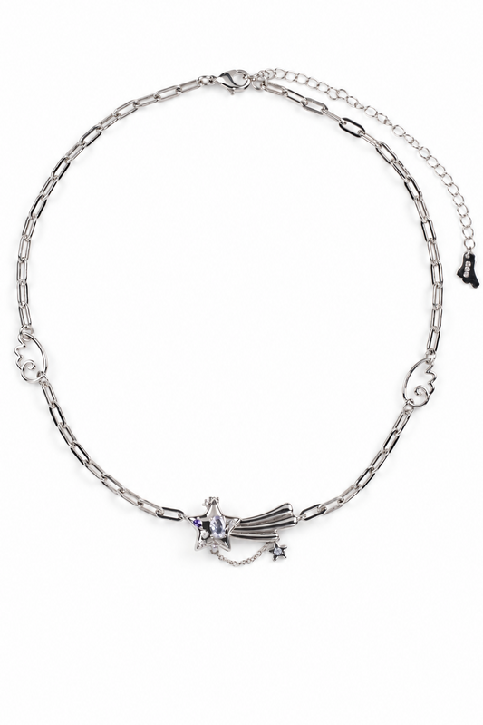 A silver-toned chain necklace featuring a central meteor or shooting star charm with small star accents, displayed on a clean white background.